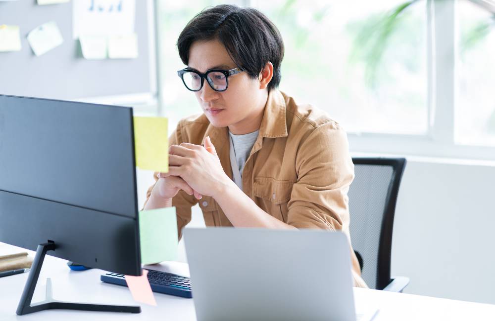 付箋を貼り、真剣な表情で画面を見つめる姿が、初心者の「できるかな？」という不安に寄り添います。