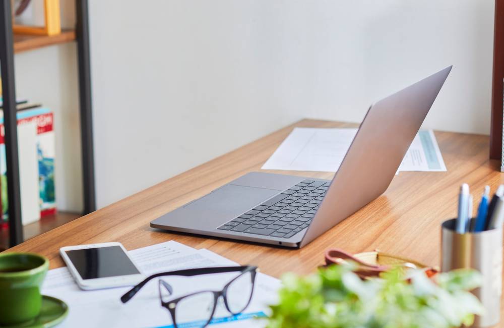 自分に合ったDELLの中古PCを選んだ後の、快適なPCライフを連想させる眼鏡やノートが置かれた清潔感のあるデスク風景